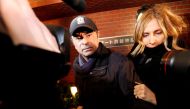FILE PHOTO: Former Nissan Motor Chairman Carlos Ghosn accompanied by his wife Carole Ghosn, arrives at his place of residence in Tokyo, Japan, March 8, 2019. REUTERS/Issei Kato