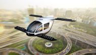 An artistic rendering of an electric vertical takeoff and landing taxi cruising through an urban center. Dave Brenner/University of Michigan School for Environment and Sustainability