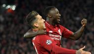 Liverpool's Guinean midfielder Naby Keita (R) celebrates with Liverpool's Brazilian midfielder Roberto Firmino after scoring a goal during the UEFA Champions League quarter-final, first leg football match between Liverpool and FC Porto at Anfield stadium 