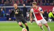 Juventus' Portuguese forward Cristiano Ronaldo (L) and Ajax's Dutch defender Matthijs de Ligt run with the ball during the UEFA Champions League first leg quarter-final football match between Ajax Amsterdam and Juventus FC at the Johan Cruijff ArenA in Am