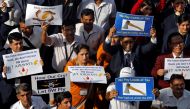 Jet Airways employees hold placards and banners during a protest demanding to 