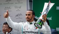 British driver Lewis Hamilton of Mercedes GP celebrates on the podium after placing first in the F1 Grand Prix of China at Shanghai International Circuit on April 14, 2019 in Shanghai, China. ( Stringer - Anadolu 