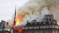 Smoke billows as fire engulfs the spire of Notre Dame Cathedral in Paris, France April 15, 2019. REUTERS/Benoit Tessier