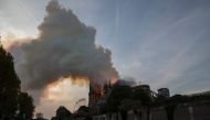 Smoke and flames billow from the roof at Notre-Dame Cathedral in Paris on April 15, 2019. AFP / Thomas Samson