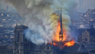  Smoke and flames rise during a fire at the landmark Notre-Dame Cathedral in central Paris on April 15, 2019, potentially involving renovation works being carried out at the site, the fire service said. / AFP / Hubert Hitier
 