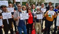 Algerian artists chant slogans as they protest against the government as they call for more liberties during a sit-in outside the Ministry of Culture headquarters in the capital Algiers on April 17, 2019.  AFP / Ryad Kramdi 