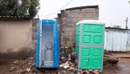 Portable toilets are photographed in an alley way between houses on April 5, 2019 in Kliptown near Soweto. AFP / Wikus De Wet 