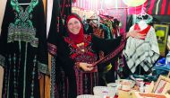 An artisan shows some of the handicraft in her stall at the traditional market at Palestine Cultural Festival.