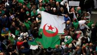 :FILE PHOTO: Demonstrators hold flags and banners as they return to the streets to press demands for wholesale democratic change well beyond former president Abdelaziz Bouteflika's resignation in Algiers, Algeria April 19, 2019. REUTERS/Ramzi Boudina shou