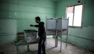 An Egyptian man casts his vote in a polling station during the third day of a referendum on constitutional amendments in Cairo on April 22, 2019.  AFP / Khaled Desouki 