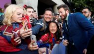 Cast member Chris Evans poses with fans on the red carpet at the world premiere of the film 