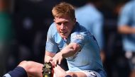 Manchester City's Belgian midfielder Kevin De Bruyne stretches on the ground after picking up an injury and before being substituted during the English Premier League football match between Manchester City and Tottenham Hotspur at the Etihad Stadium in Ma
