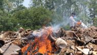 A Nepali park worker burns wildlife parts seized from poachers at Chitwan National Park, 250 kms south of Kathmandu on May 22, 2017. AFP