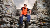 Northern Adelaide Waste Management Authority supervisor Thao Nguyen posing amongst recycled plastic bottles at the recycling site in Edinburgh, near Adelaide, on April 17, 2019.  AFP / Brenton Edwards