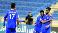 Al Shahania’s Ramin Einollah celebrates with team-mate Reza Najafi after scoring his second goal against Al Markhiya during the third round of the Amir Cup at the Thani bin Jassim Stadium in Doha, yesterday.
