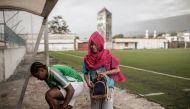 Football Club Mamans (F.C. Mamans) Nadjima Bacar (R) and Hairiat Abdourahmane (L) , Captain of the Comoros Women Football National team get ready for a training session in Moroni, Comoros on March 23, 2019. AFP / Gianluigi Guercia 