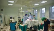 Romanian surgeons and assistant personnel are pictured inside an operation room during medical procedures at the local hospital in the eastern town of Slobozia March 27, 2019.  AFP / Daniel Mihailescu
 