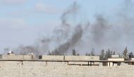 Smoke rises during a fight between members of the Libyan internationally recognised government forces and Eastern forces in Ain Zara, Tripoli, Libya April 28, 2019. REUTERS/Ismail Zitouny