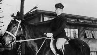 This file photo taken in the 50s shows Prince Akihito posing on horseback at an unknown location.  AFP
