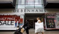 In this file photo taken on June 19, 2018 Shoppers walk past a Debenhams shop in Oxford Street, central London on June 19, 2018. AFP / Tolga Akmen 
 