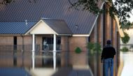 Church member John Batiste checks the flood levels around St. Mark Church of Christ after the effects of Hurricane Matthew in Goldsboro, North Carolina, October 12, 2016. Reuters/Randall Hill
