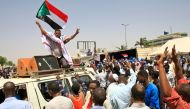 Sudanese protesters, waving national flags, take part in a sit-in outside the army headquarters in Khartoum on May 5, 2019.  AFP / ASHRAF SHAZLY
