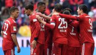 Several Bayern Munich players celebrate after the third goal for Munich during the German first division Bundesliga football match FC Bayern Munich vs Hanover 96 in the stadium in Munich, southern Germany, on May 4, 2019.   AFP / Christof STACHE