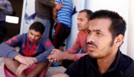 Migrants, who were rescued after their boat capsized in the Mediterranean Sea off the Tunisian Coast after they had left Libya, are seen inside a local Red Cresent chapter in Zarzis, Tunisia May 11, 2019. REUTERS/Zoubei Souissi