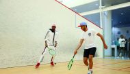 Qatar’s Abdulla Al Tamimi (right) and world champion in high jump Mutaz Barsim of Qatar play squash during the opening ceremony of Al Tamimi’s ATA Sports Academy.
