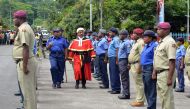 This picture taken on March 4, 2019 shows parade commander Julie Palakai (L) escorting East New Britain’s new residential Judge Justice Stephen Kassman (R) during a guard of honour parade outside Kokopo Police station in Kokopo, Papua New Guinea. AFP / El
