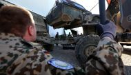 FILE PHOTO: German military experts work on an army vehicle at a workshop for Peshmerga forces in Erbil. AFP / SAFIN HAMED
