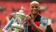 Manchester City's Belgian captain Vincent Kompany holds the winner's trophy after the English FA Cup final football match between Manchester City and Watford at Wembley Stadium in London, on May 18, 2019. AFP / Daniel Leal-Olivas 
