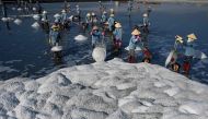 This photograph taken on April 22, 2019 shows workers harvesting salt in southern Vietnam's Hon Khoi salt fields. AFP / Manan Vatsyayana


