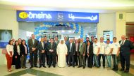 Sheikh Faisal bin Qassim Al Thani (centre), Chairman of Aamal Company, posing for a group picture with the employees at the reopening of its pharmacy at the City Center Mall after its complete renovation.