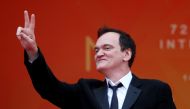 US film director Quentin Tarantino flashes the victory sign as he arrives for the screening of the film 