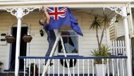 New Zealand All Blacks fan Brett Plumer nails a national flag to his house in Auckland September 9, 2011 ahead of the Rugby World Cup opening match. Reuters