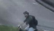This handout video frame grab from a surveillance camera made available by the French National Police on their Twitter account on May 25, 2019 shows a male riding a mountain bike in the vicinity of a suspect package bomb blast that took place along a pede