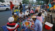 Vendors eat their iftar meals in front of their garment shops on a roadside in Kolkata, India May 28, 2019. Reuters/Rupak De Chowdhuri