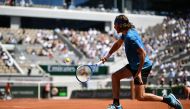 :Greece's Stefanos Tsitsipas returns the ball to Serbia's Filip Krajinovic during their men's singles third round match on day seven of The Roland Garros 2019 French Open tennis tournament in Paris on June 1, 2019. / AFP / Philippe LOPEZ