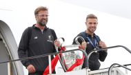 Liverpool's Jordan Henderson and manager Juergen Klopp emerge from an aeroplane with the trophy as they arrive back in Liverpool after winning the Champions League Final. Reuters/Craig Brough