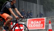 British police officers stand on duty behind the security fences in Regents Park, erected around The Residence of the US Ambassador to the UK, Winfield House, where US President Donald Trump is expected to stay during his visit this coming week, in centra
