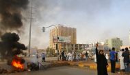 A Sudanese protester flashes the V sign for victory outside Khartoum's army headquarters on June 3, 2019.  AFP / ASHRAF SHAZLY