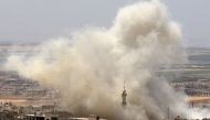 Smoke plumes following reported airstrikes on the town of Khan Sheikhun in the southern countryside of the rebel-held Idlib province on June 3, 2019. / AFP / Anas AL-DYAB