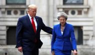 Britain's Prime Minister Theresa May and U.S. President Donald Trump walk through the Quadrangle of the Foreign Office for a joint news conference in central London, Britain June 4, 2019. Frank Augstein/Pool via REUTERS