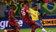 Brazil's Gabriel Jesus (R) kicks the ball next to Qatar's Pedro Correira (L) and Qatar's Boualem Khoukhi during a friendly football match at the Mane Garrincha stadium in Brasilia on June 5, 2019, ahead of Brazil 2019 Copa America. / AFP / EVARISTO SA 