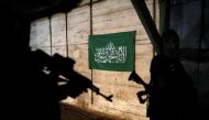 Actors are silhouetted next to a Hamas flag, on the set of Israeli television series 