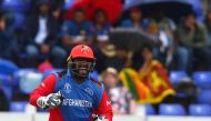 Afghanistan's Mohammad Shahzad celebrates Sri Lanka's Kusal Perera's dismissal for 78 during the 2019 Cricket World Cup group stage match between Afghanistan and Sri Lanka at Sophia Gardens stadium in Cardiff, south Wales, on June 4, 2019.  AFP / Geoff Ca