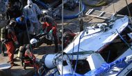 Rescue workers recover a body as they lift the sunken sightseeing boat 