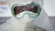FILE PHOTO: A member of the medical staff of the Ebola Treatment Unit (ETU) puts on her Personal Protective Equipment (PPE) during a weekly rehearsal at the Bwera General Hospital in Bwera bordering with DRC, western Uganda. AFP / Isaac Kasamani
