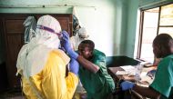Health workers wear protective equipment as they prepare to attend to suspected Ebola patients at Bikoro Hospital in the Democratic Republic of Congo on May 12, 2018. AFP/UNICEF/Mark Naftalin